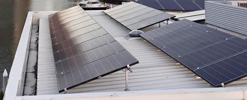 Tilted solar panel systems on flat roofs